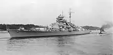 Black and white photograph of the port side of a Bismarck class battleship.