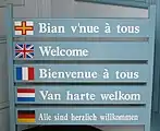 Sign in Guernsey using the Flag of Guernsey to symbolise Guernésiais.